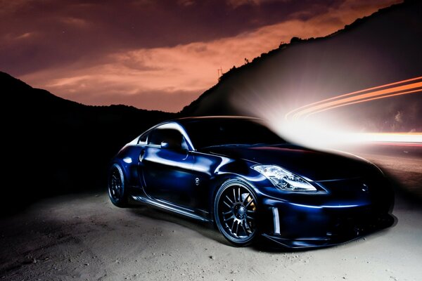 A Nissan car on the road in a crimson sunset