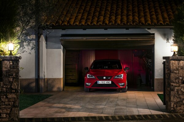 Red car in front of the house