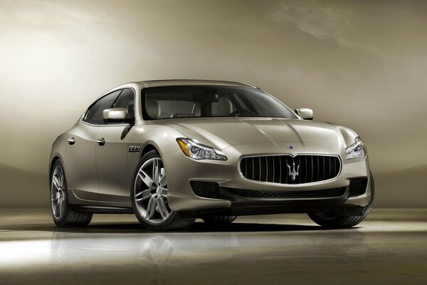 Grey Maserati on a gold background