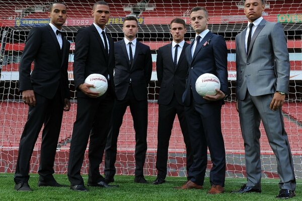 Football players in suits at the stadium