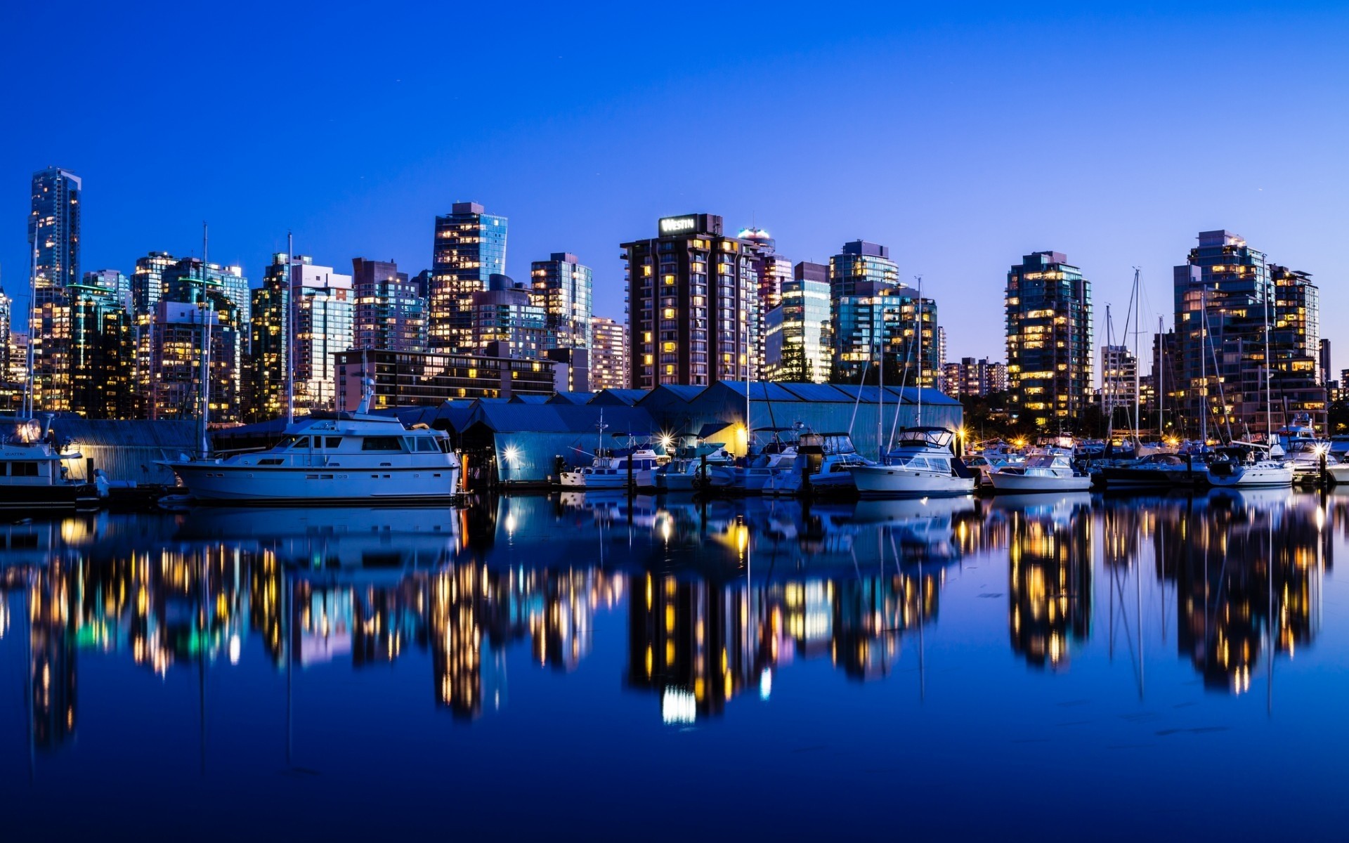 other city reflection city water dusk travel architecture sky evening cityscape sunset building harbor waterfront modern skyline urban pier business downtown night landscape boats lights