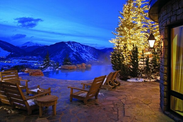 Image of a veranda with tables overlooking the mountains