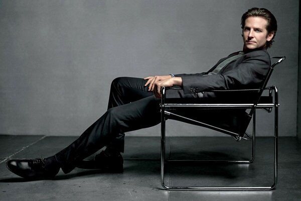 Fashion photo of an actor sitting on a chair