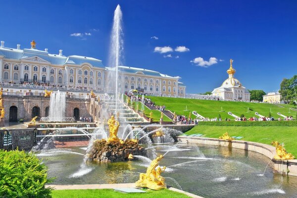 A palace in St. Petersburg with a fountain in summer