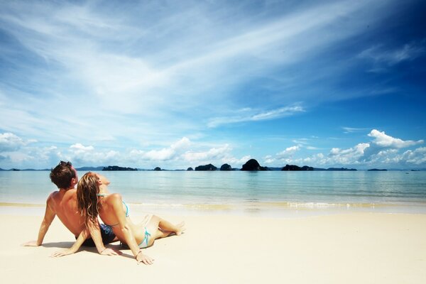 Young couple on the beach by the sea