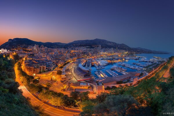 Coastal evening city illuminated by lanterns