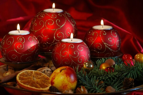 Red Christmas candles and fruits