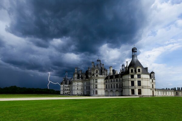 Castle of ancient architecture on the background of a thunderstorm in France