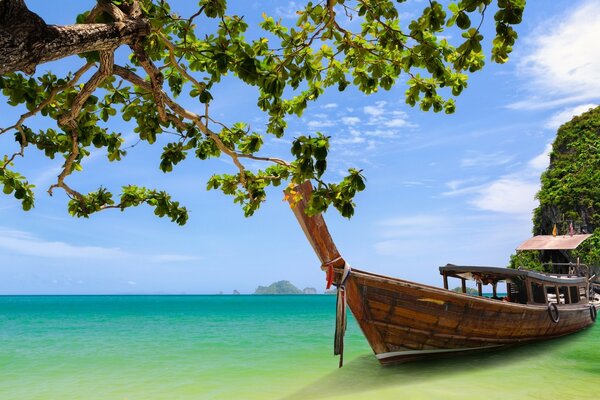 A boat in the azure ocean against a clear sky