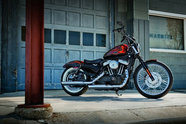 A red motorcycle is parked at the garage