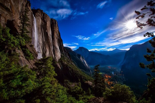 A series of mountains with a waterfall in the daytime