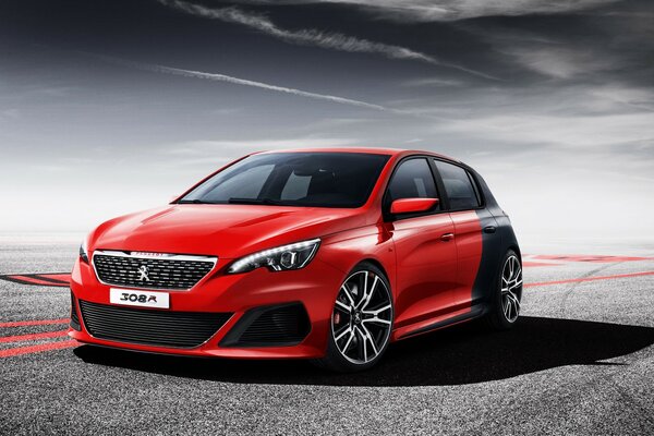 Red and black Peugeot car on the road