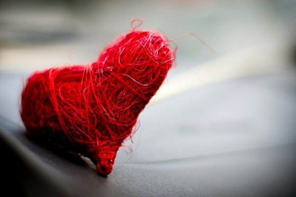 Bright red heart made of threads