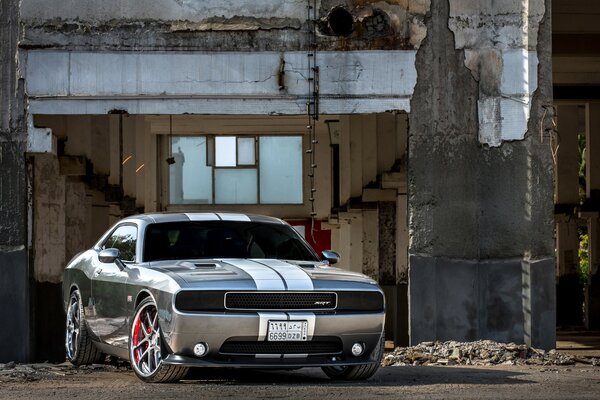 A gray car at an abandoned house