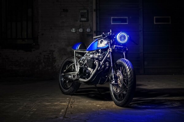 Standing blue motorcycle in the dark