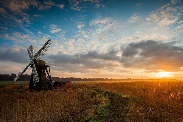 Windmill on sunset background