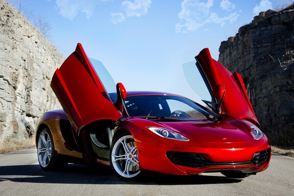 A fashionable red car with folding doors. Luxury car