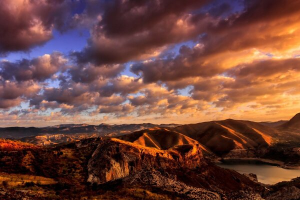 Golden clouds over a mountain lake