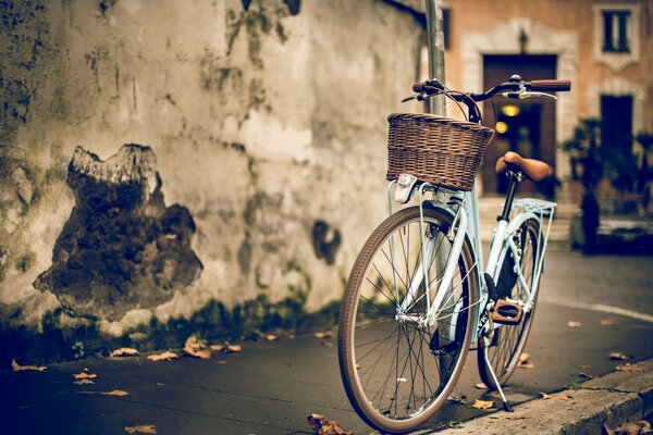 Retro bicycle with a basket on the city street 