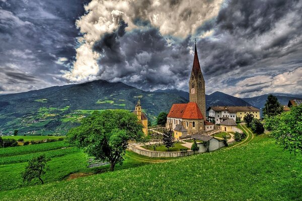 A church on the background of mountains in Italy