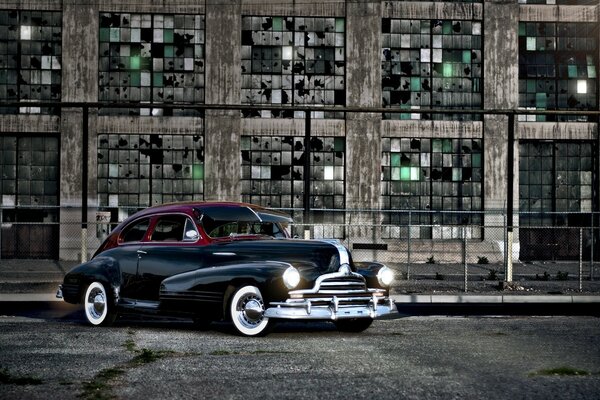 Retro car near the old wall