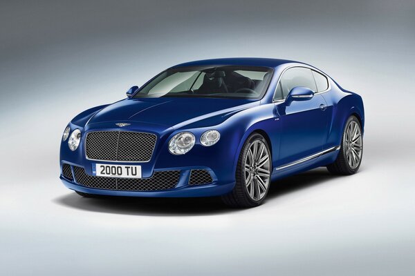 A blue Bentley stands on a white background