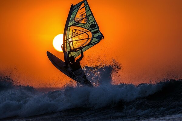 Surfing in the evening against the background of sunset