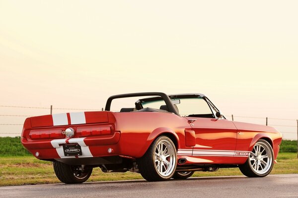 Red Ford convertible on an asphalt road