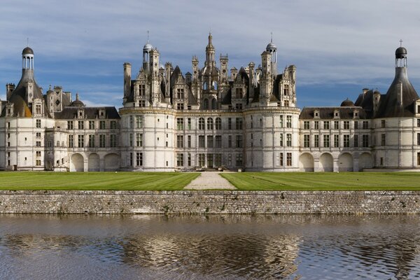 An old stone castle with towers on the shore