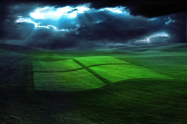 Das Windows-Logo, das auf einer grünen Wiese reflektiert wird und von den Sonnenstrahlen durch die Wolken beleuchtet wird