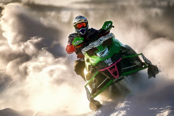 A snowcat racer leaves a cloud of snow behind him