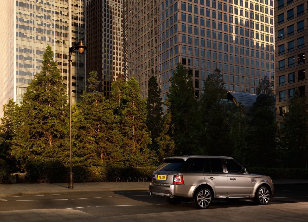 suvs city street car building road urban downtown travel business architecture outdoors light office sky