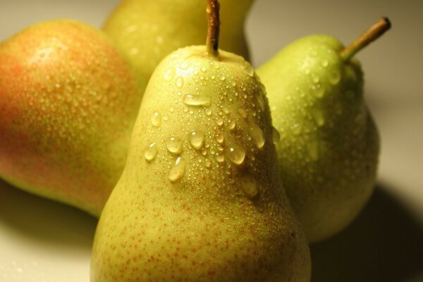 A ripe pear. Water droplets