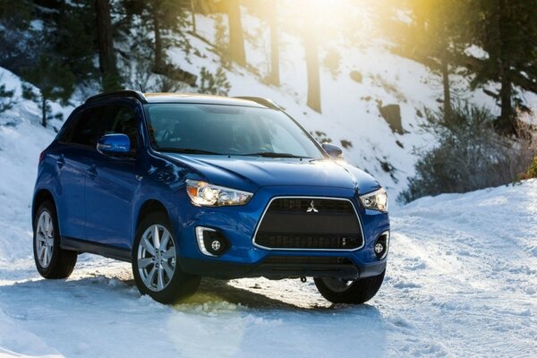 Blue car on white snow