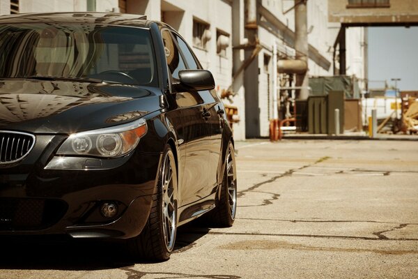 A car on the street next to garbage cans