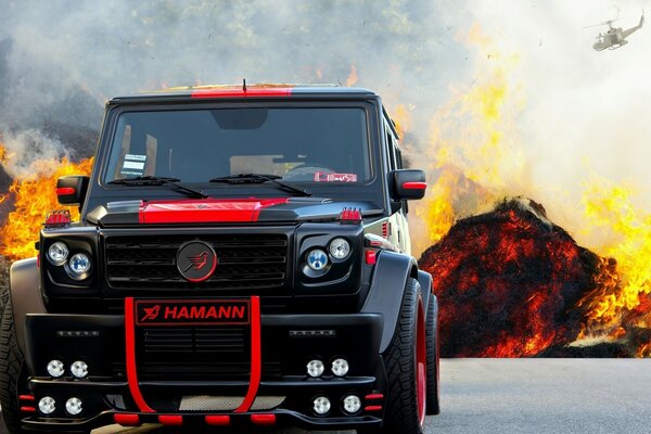 Car on the background of burning mountains