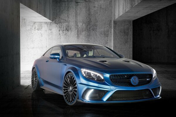 Blue Mercedes Benz on a gray wall background