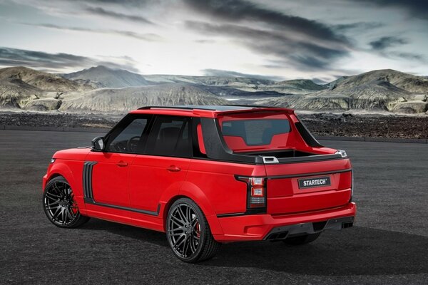 Red range rover and mountains