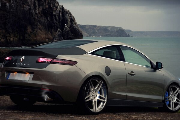 Gray sports car on the shore