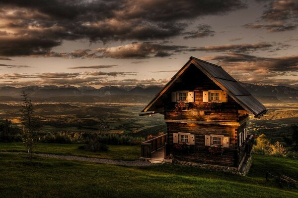 Haus auf einem Hügel bei Sonnenuntergang