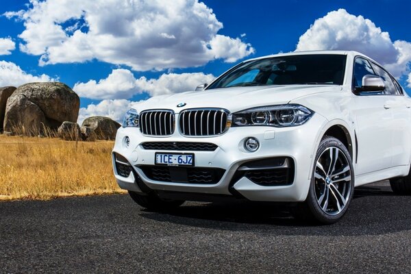 White bmw cuts through the roads