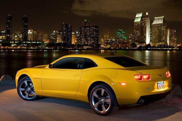 Sports yellow car on the background of houses