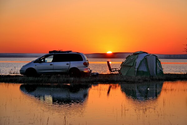 Dawn over the water with a tent