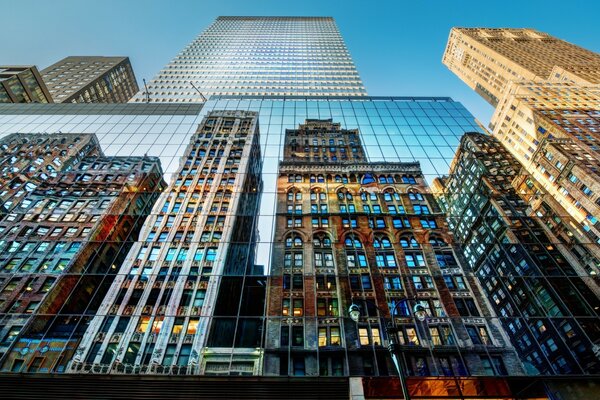 Urban architecture reflected from the mirrored walls of a skyscraper