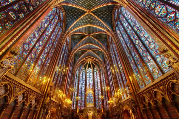 The high arches of the cathedral are decorated with patterns of colored glass