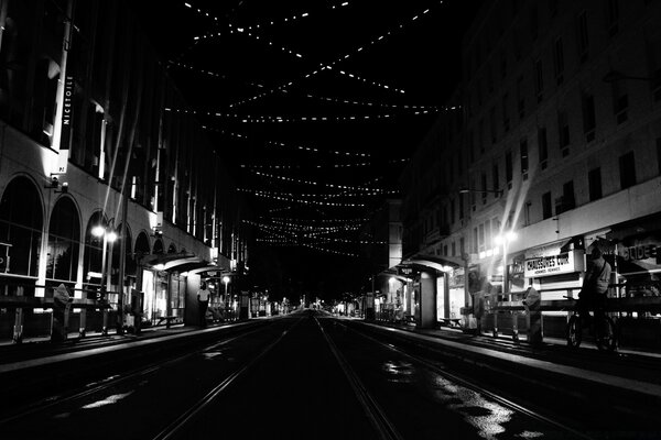 A monochrome street is driven by a transport system