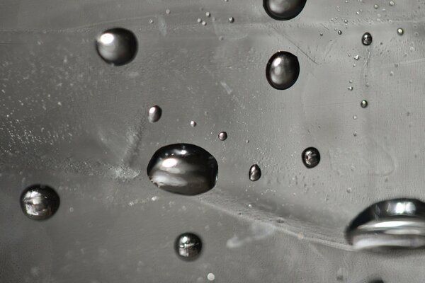 Drops on the glass. Black and white macro photography