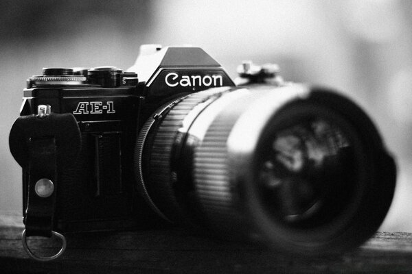 Black and white image of a camera with a large lens