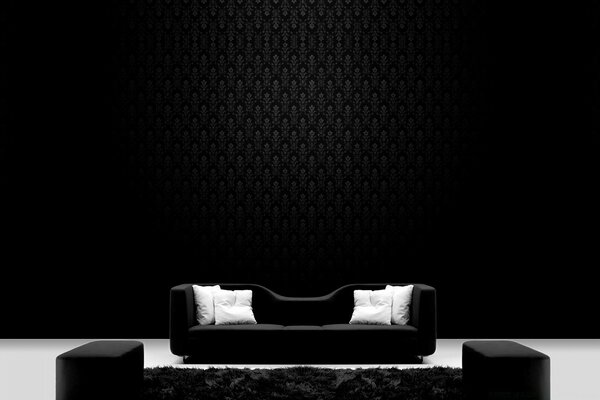 Black and white pillows on a black wall background