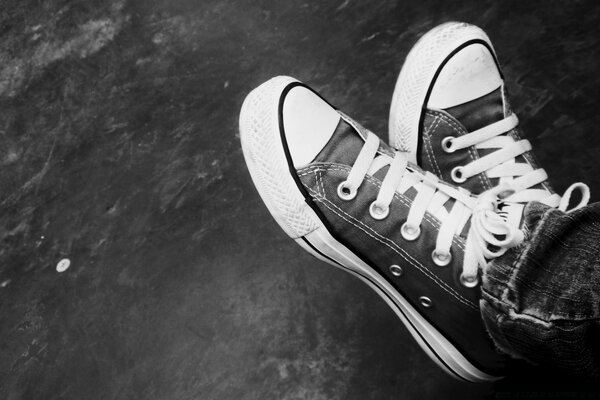 Sneakers on the feet in black and white